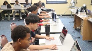 DDI students critiquing each other's video game.