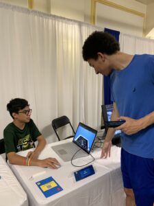 A guest plays a DDI student's video game.