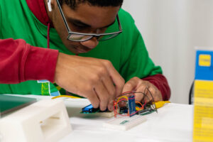 TYH student assembles his Arduino part of the design.