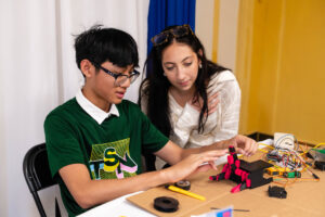 TYH instructor preps student for his final presentation.