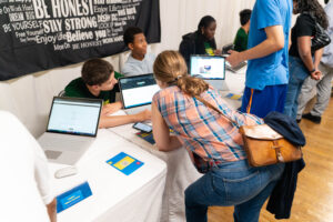 A guest admires a student 's website he created.
