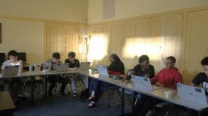 With the help of his instructor, a student works on his prototype design.